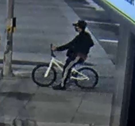 Image of suspect and white bicycle in Edmonton robbery and assault.