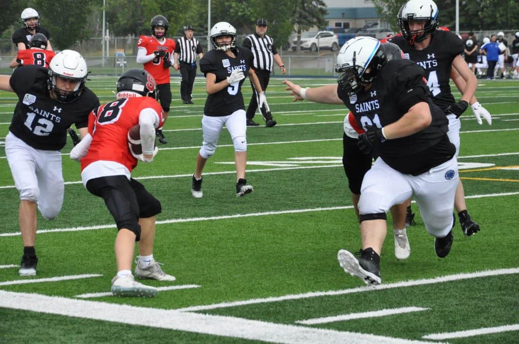 Lucas Brown (18) scores a touchdown in his first game