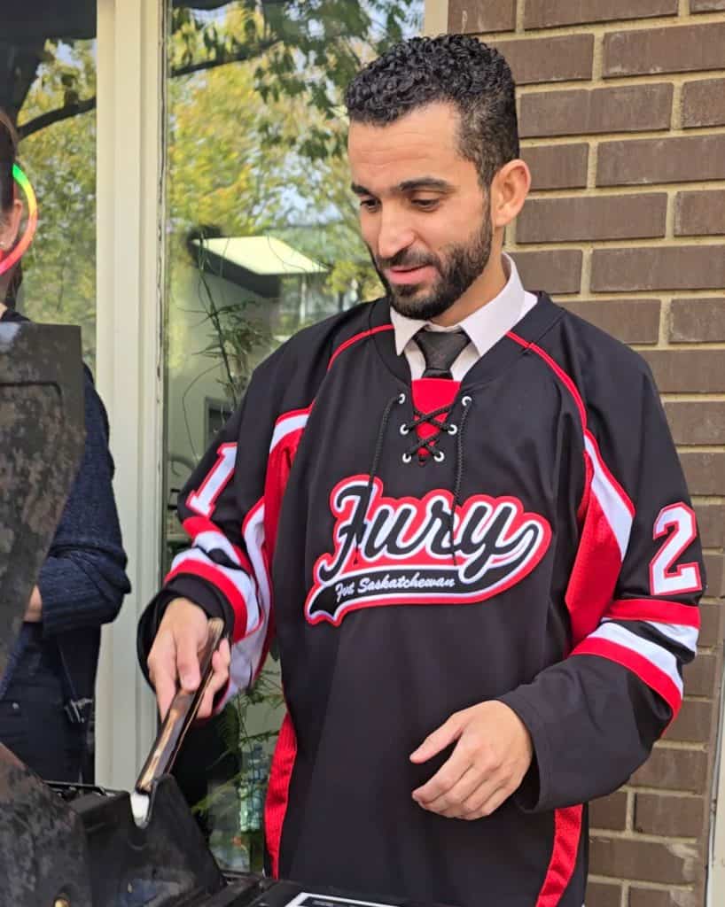 Store owner, Omar Bakali grilling up some BBQ, preparing food for families during the event.