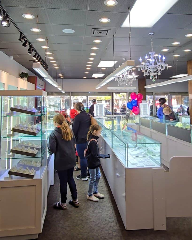 Inside Legacy Jewellers during the event, children and families looking at the elegant jewelry displays.