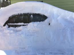 Car buried in snow.