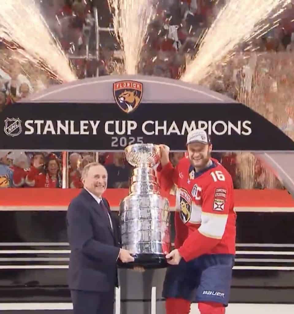 NHL Commissioner Gary Bettman presents Florida Panthers captain Aleksander Barkov with the Stanley Cup.