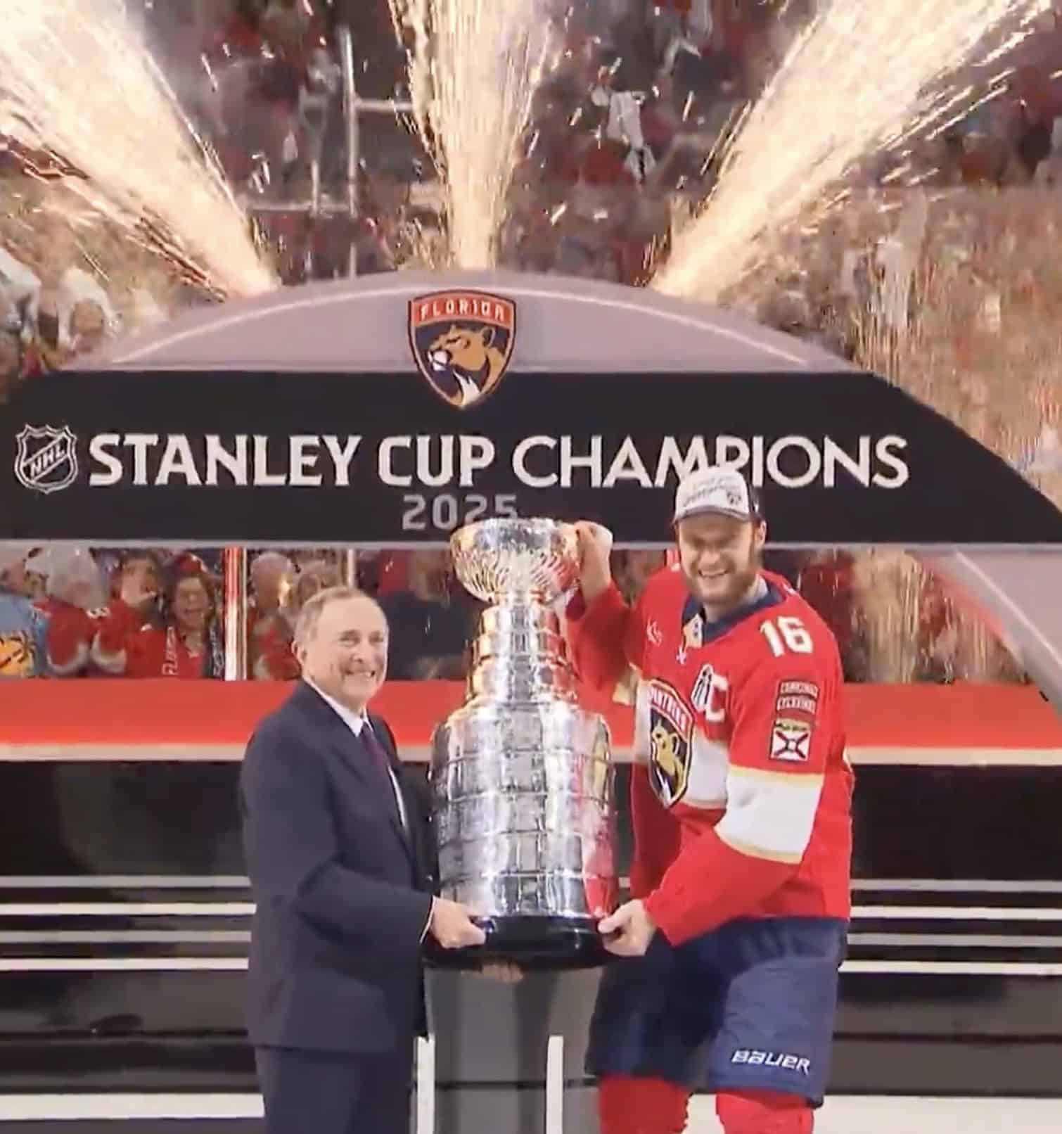 NHL Commissioner Gary Bettman presents Florida Panthers captain Aleksander Barkov with the Stanley Cup.